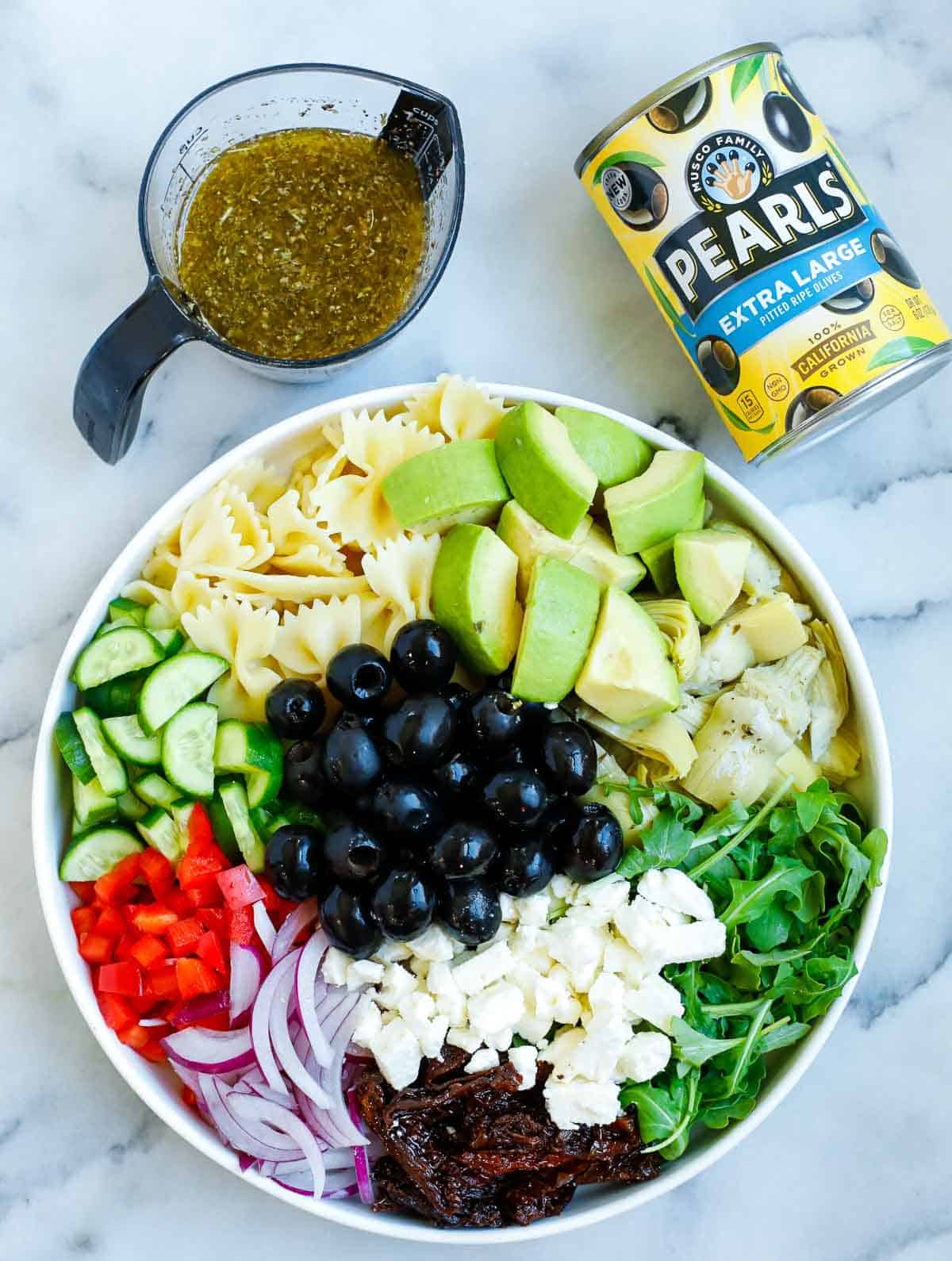 Ingredients for the pasta salad in a bowl before adding the dressing.