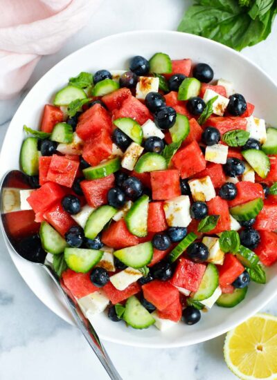 top down shot of watermelon feta salad in a bowl with a spoon