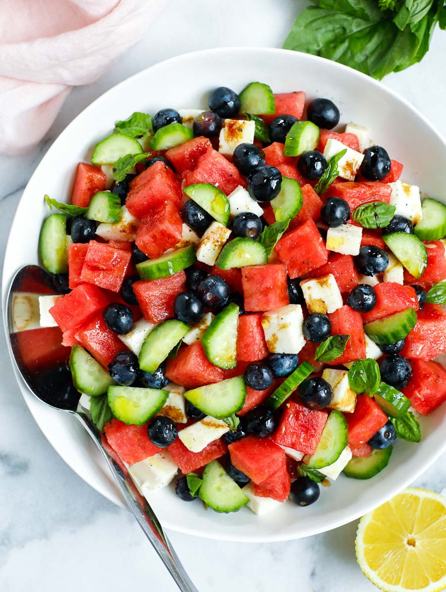top down shot of watermelon feta salad in a bowl with a spoon