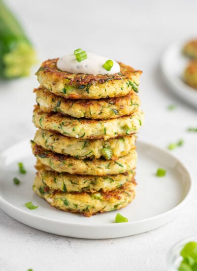 several zucchini fritters stacked on top of each other