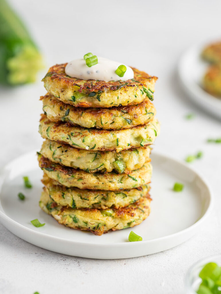 several zucchini fritters stacked on top of each other