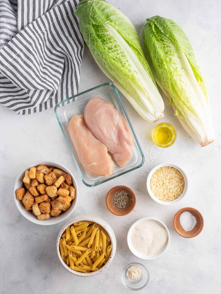 ingredients of chicken ceasar pasta salad laid out