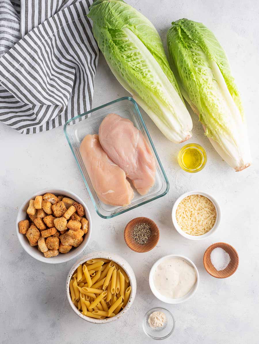 ingredients of chicken ceasar pasta salad laid out