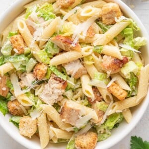 chicken ceasar pasta salad in a white bowl
