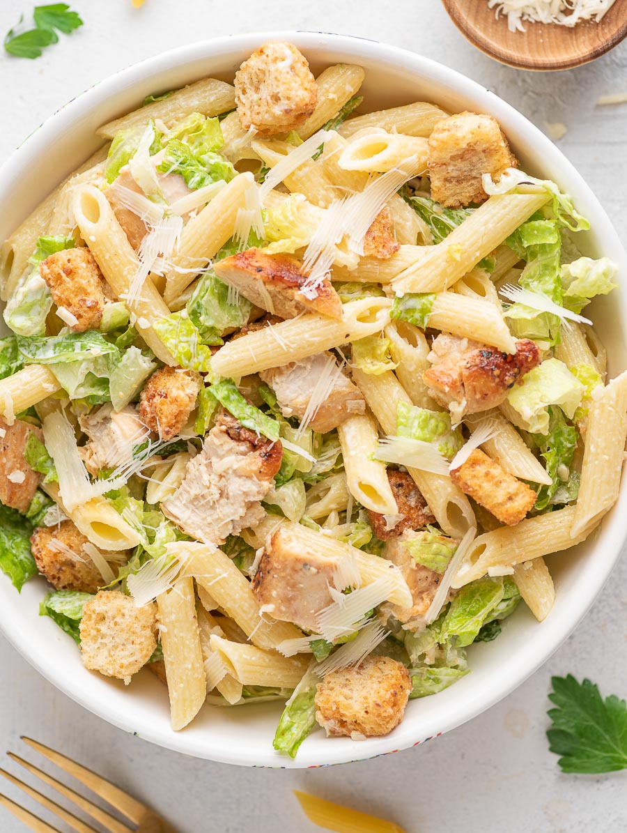 chicken ceasar pasta salad in a white bowl