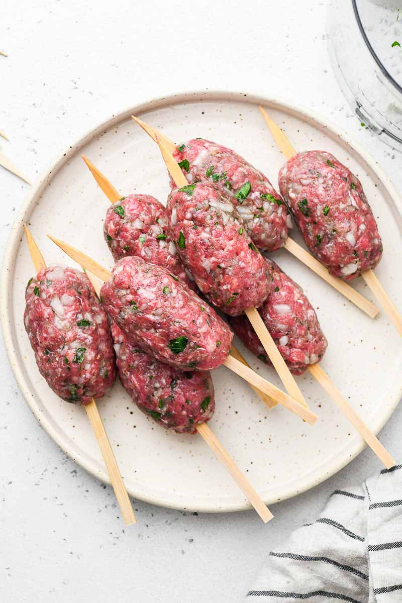 raw beef kofta skewers on a plate