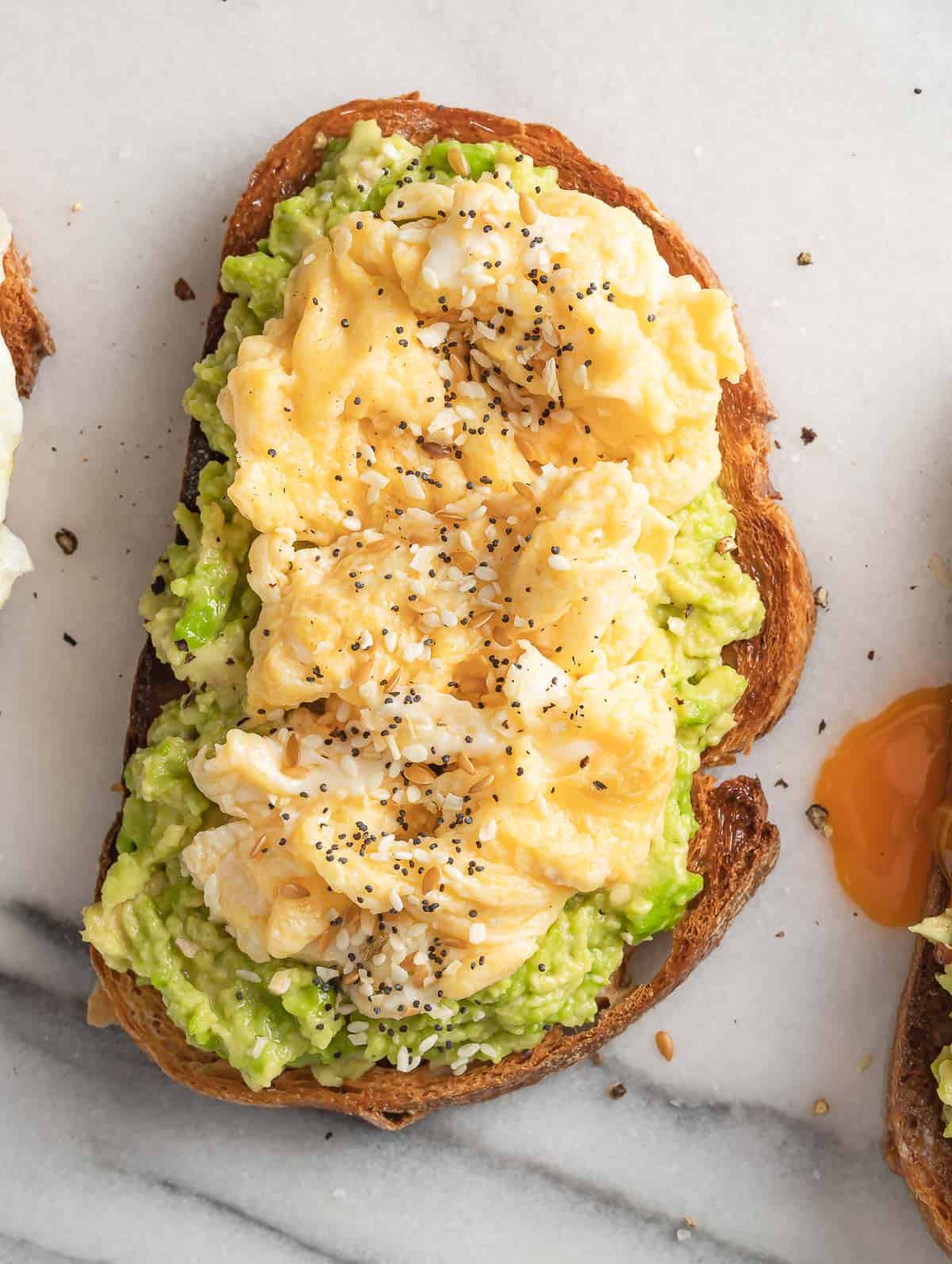Avocado on toast bread topped with scrambled egg