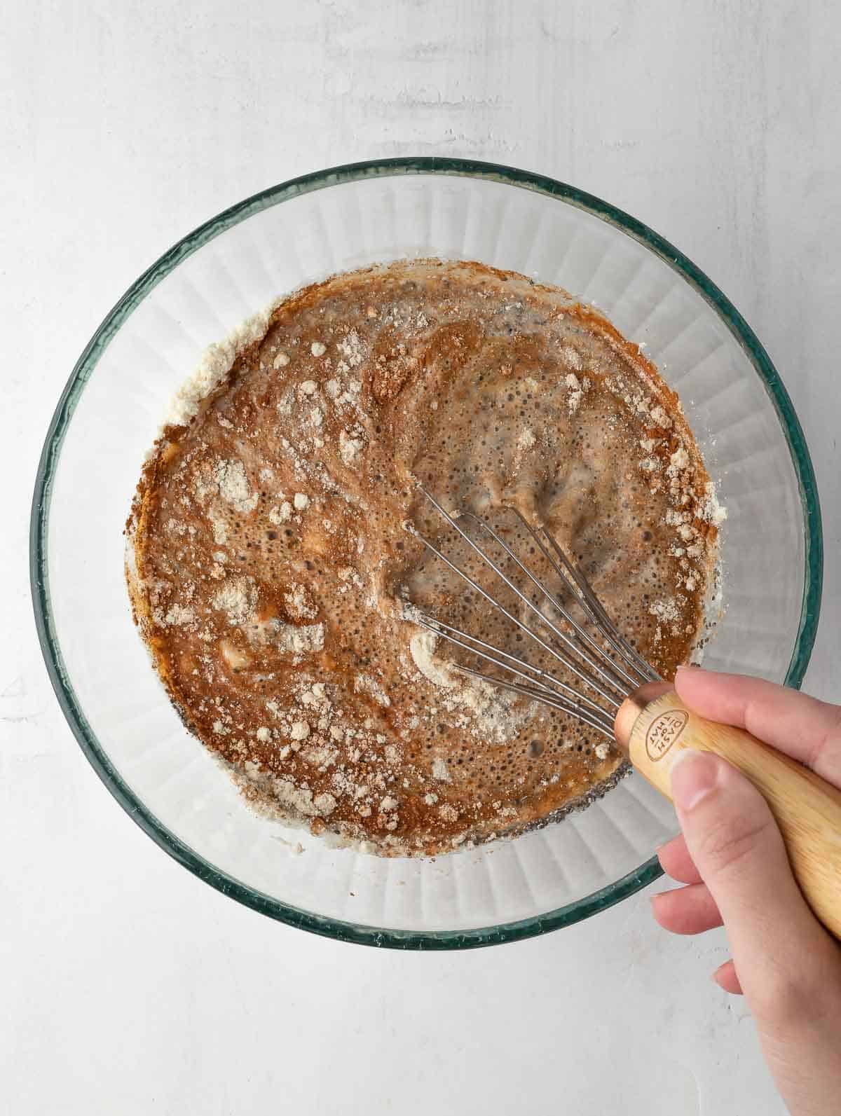 whisk mixing all ingredients together in a bowl.