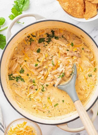 white chili chicken in a pot after being cooked with a spoon in the pot