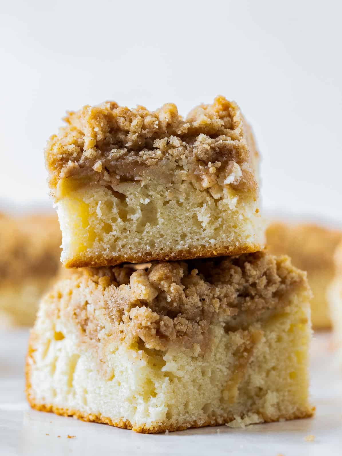 two apple crumb cake pieces stacked on top of each other.