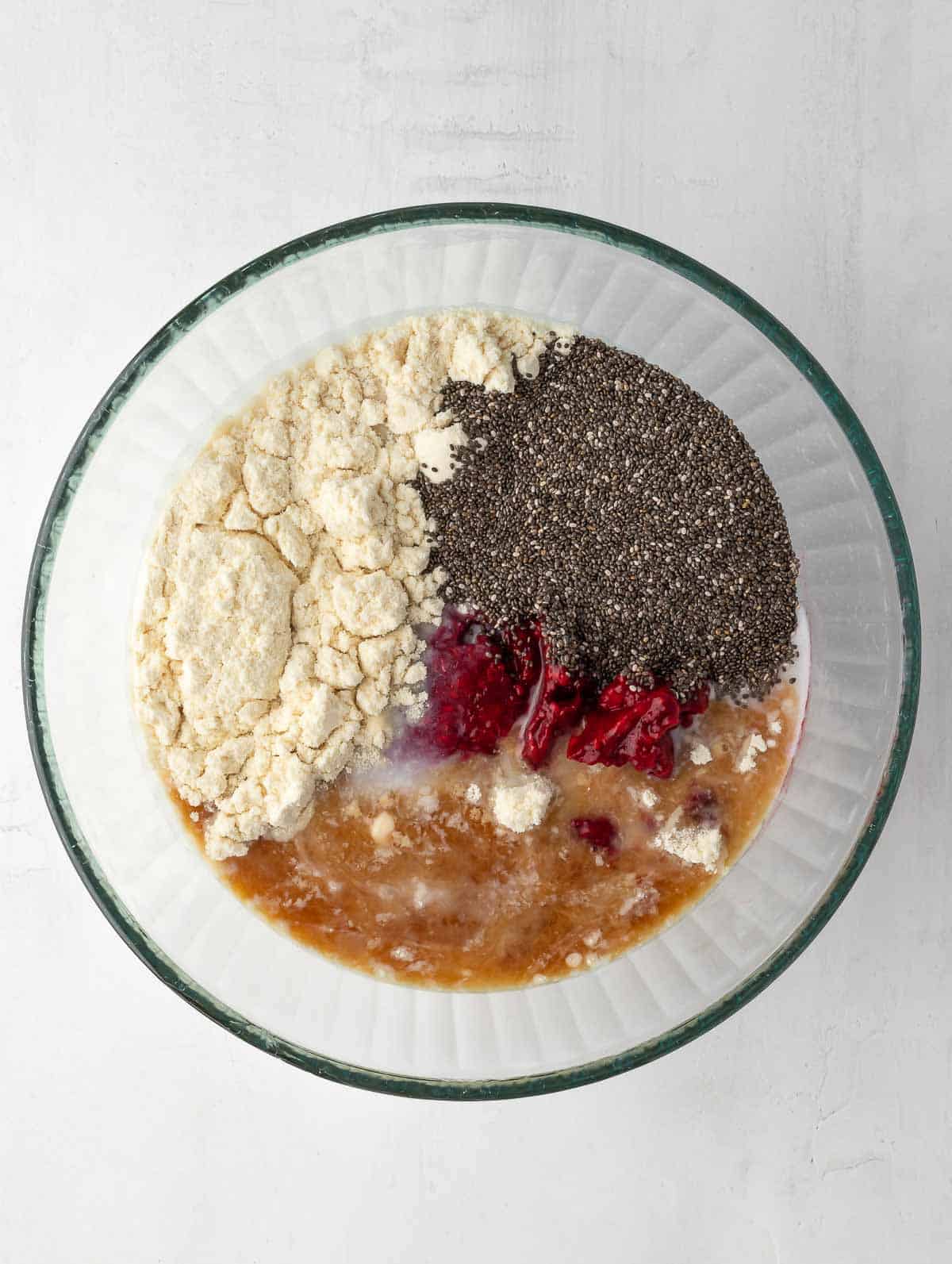 raspberry protein chia pudding ingredients placed in a bowl