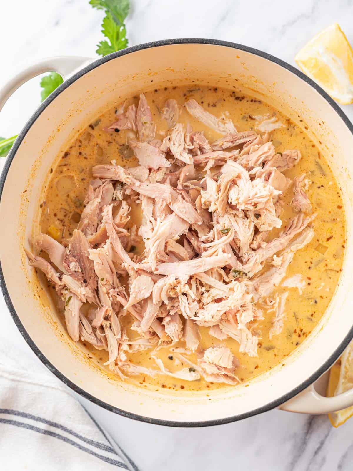 Easy White Chicken Chili Recipe in pot after adding shredded chicken