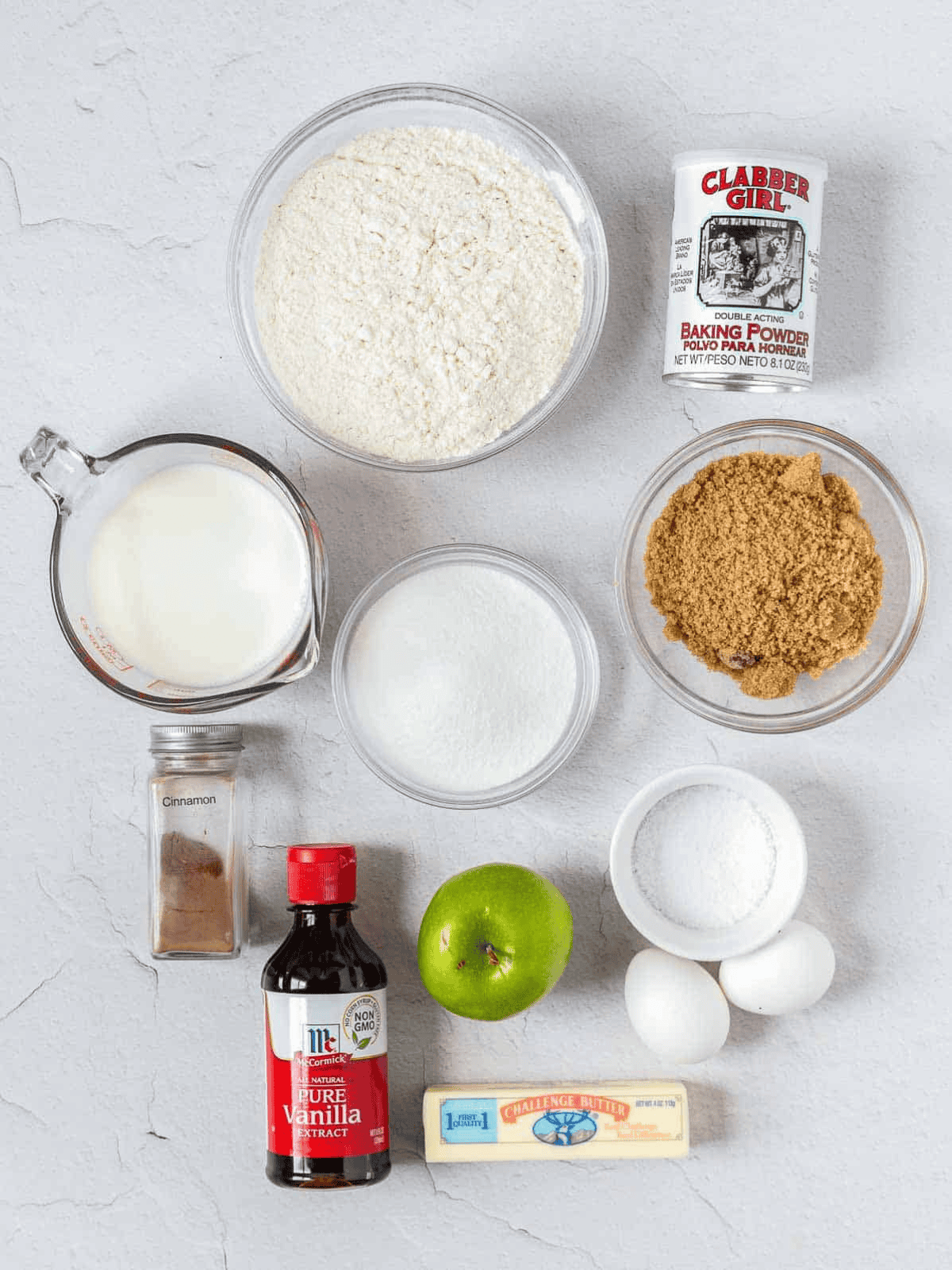 Flour, sugars, milk, butter, eggs, apple, cinnamon, and baking ingredients.
