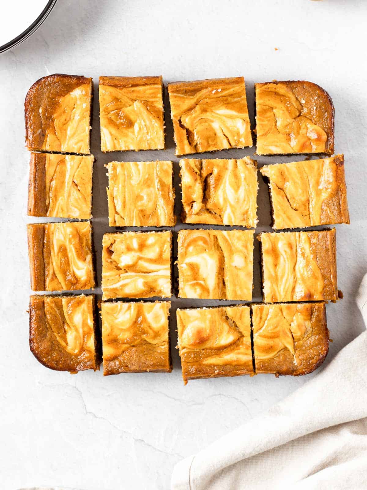 Cheesecake Swirled Pumpkin Bars cut into square