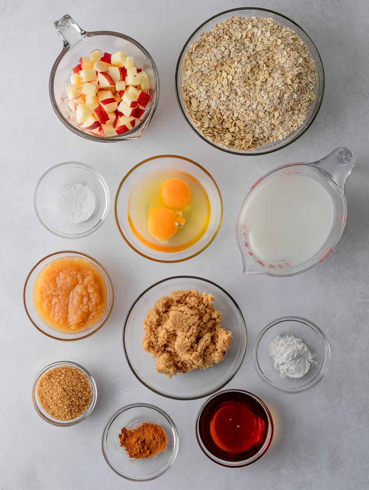 Ingredients needed to make cinnamon baked apple oats cups.