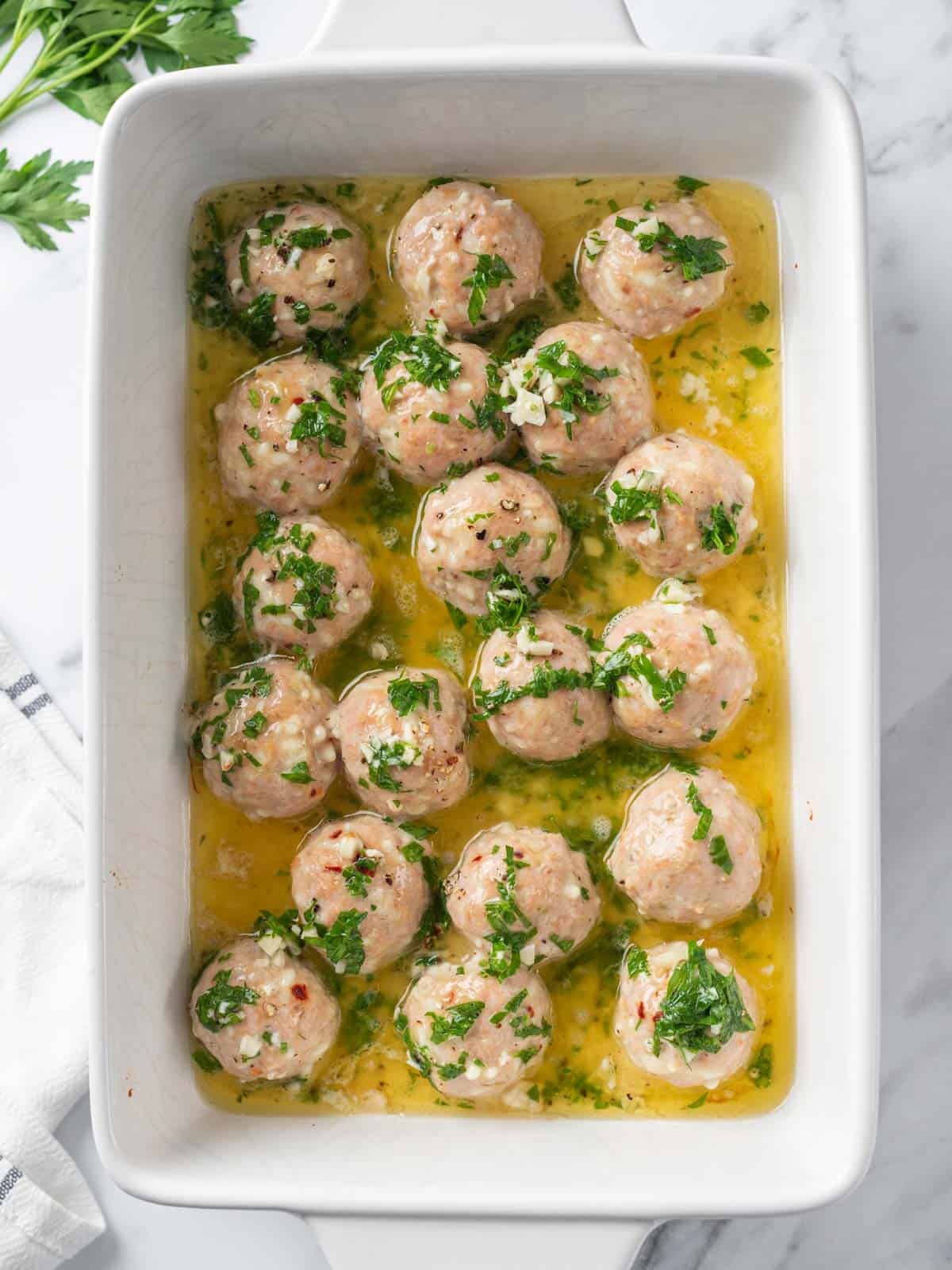 garlic butter sauce poured over semi baked turkey meatballs.