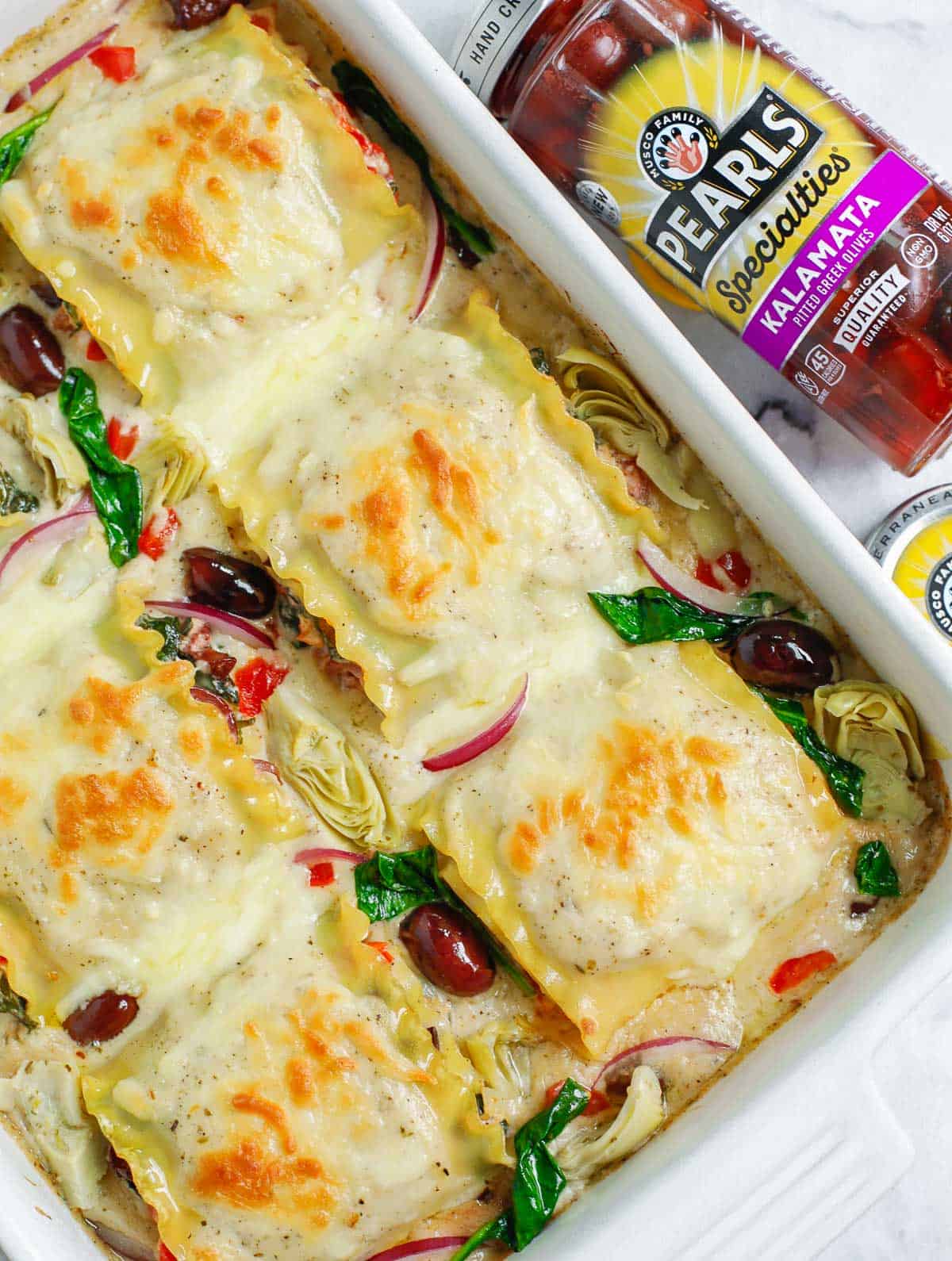 top down shot of the Greek White Alfredo Lasagna in a baking dish