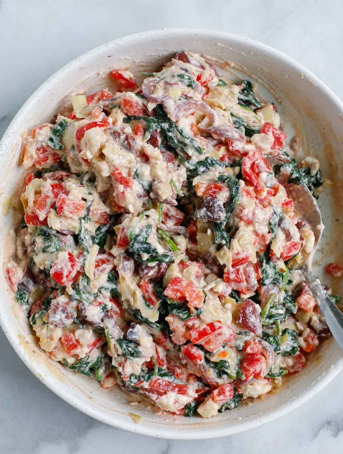 stuffing of the Greek White Alfredo Lasagna in a white bowl.