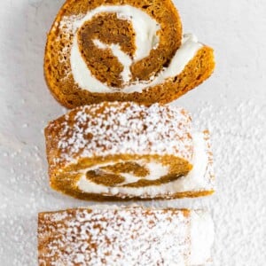 pieces of pumpkin cake roll cut out and dusted with powdered sugar