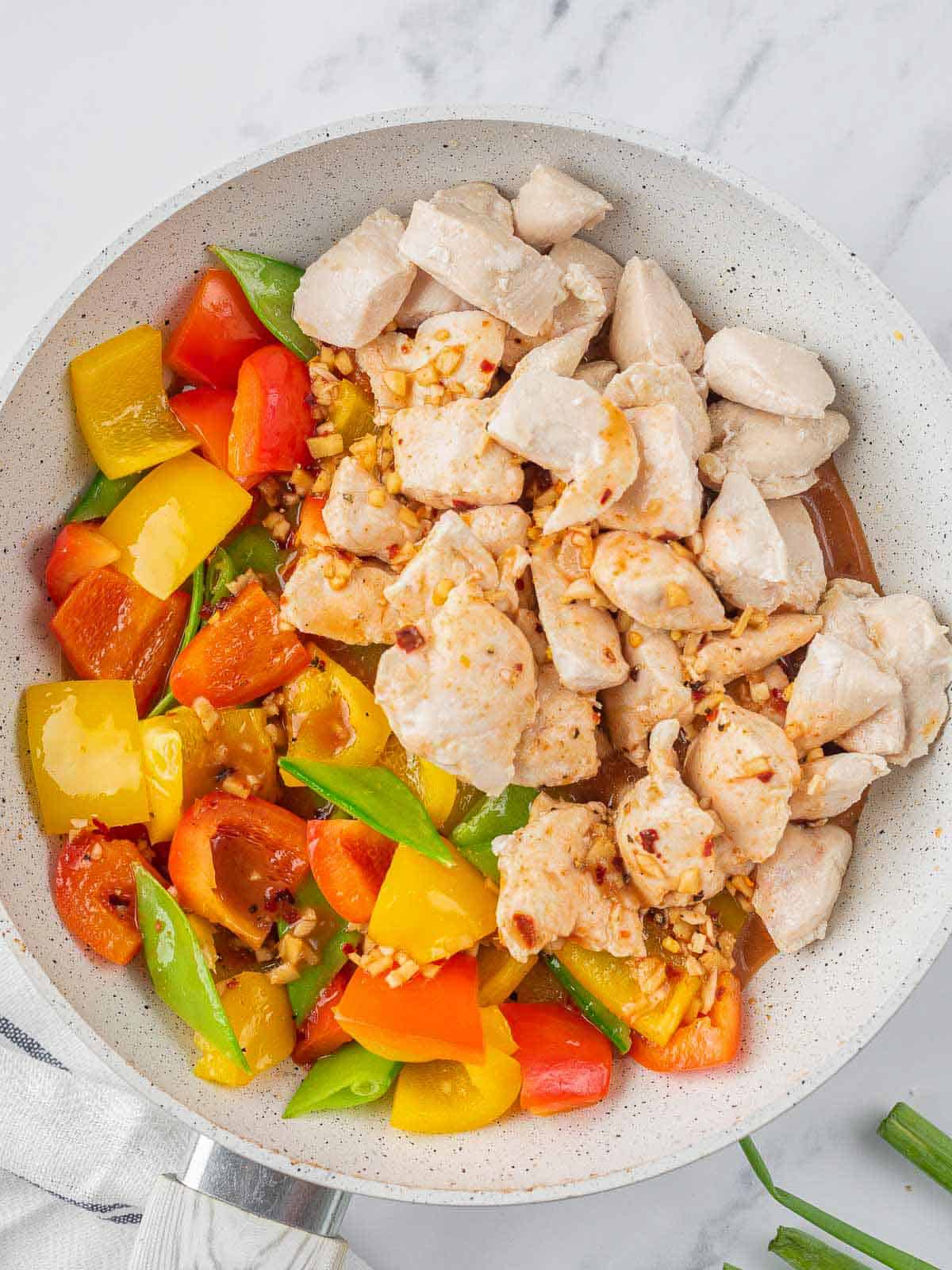 Chicken added to the pan of vegetables.