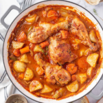 Golden chicken pieces with potatoes, carrots and celery in a thick tomato broth.
