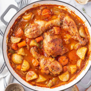 Golden chicken pieces with potatoes, carrots and celery in a thick tomato broth.