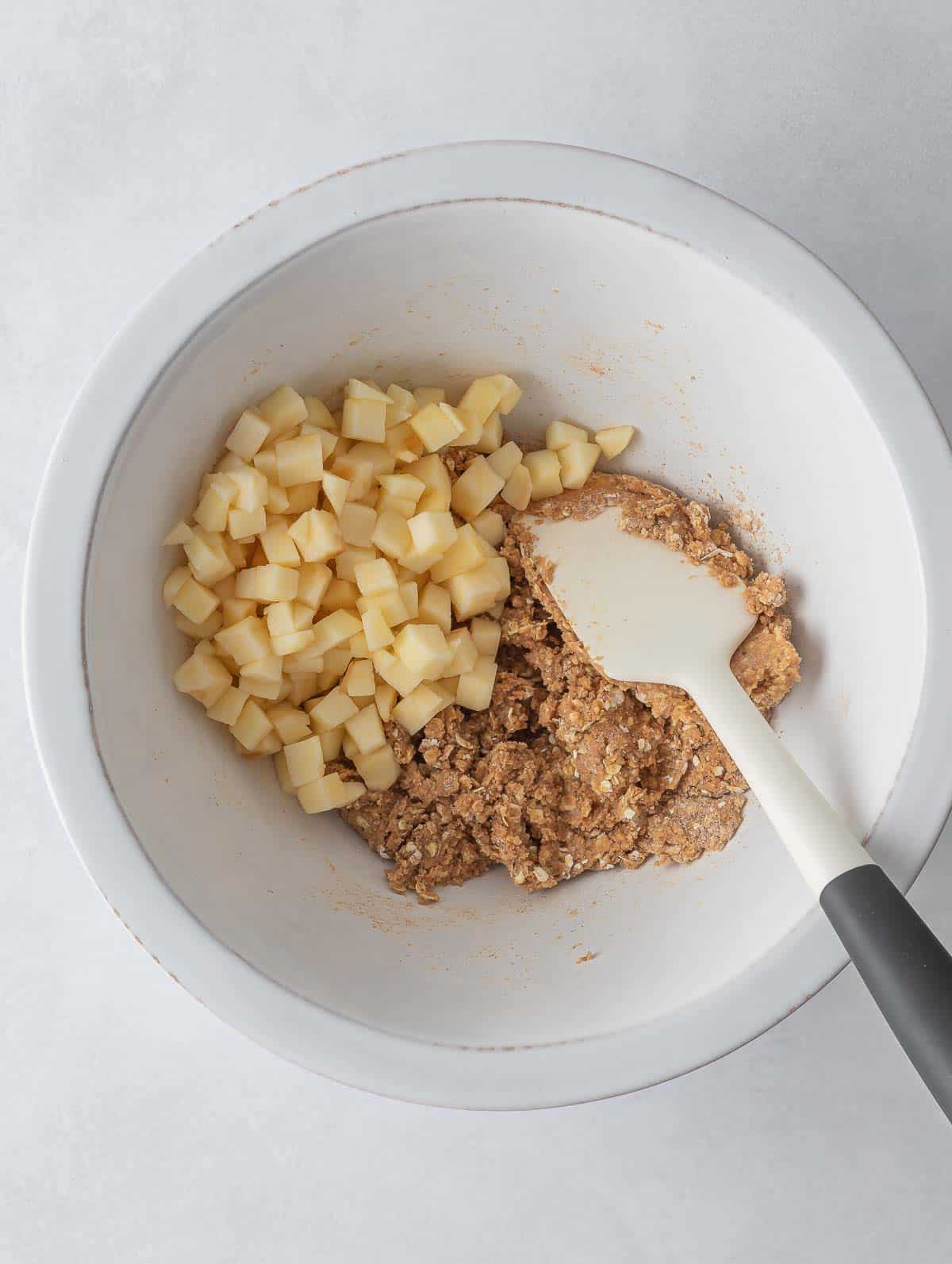 Diced apples added to cookie dough.