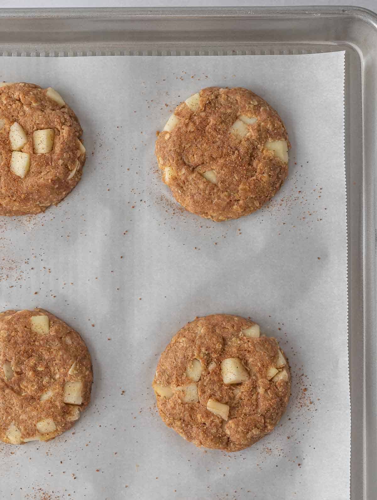 A sheet pan with healthy apple pie oatmeal cookies, before baking.