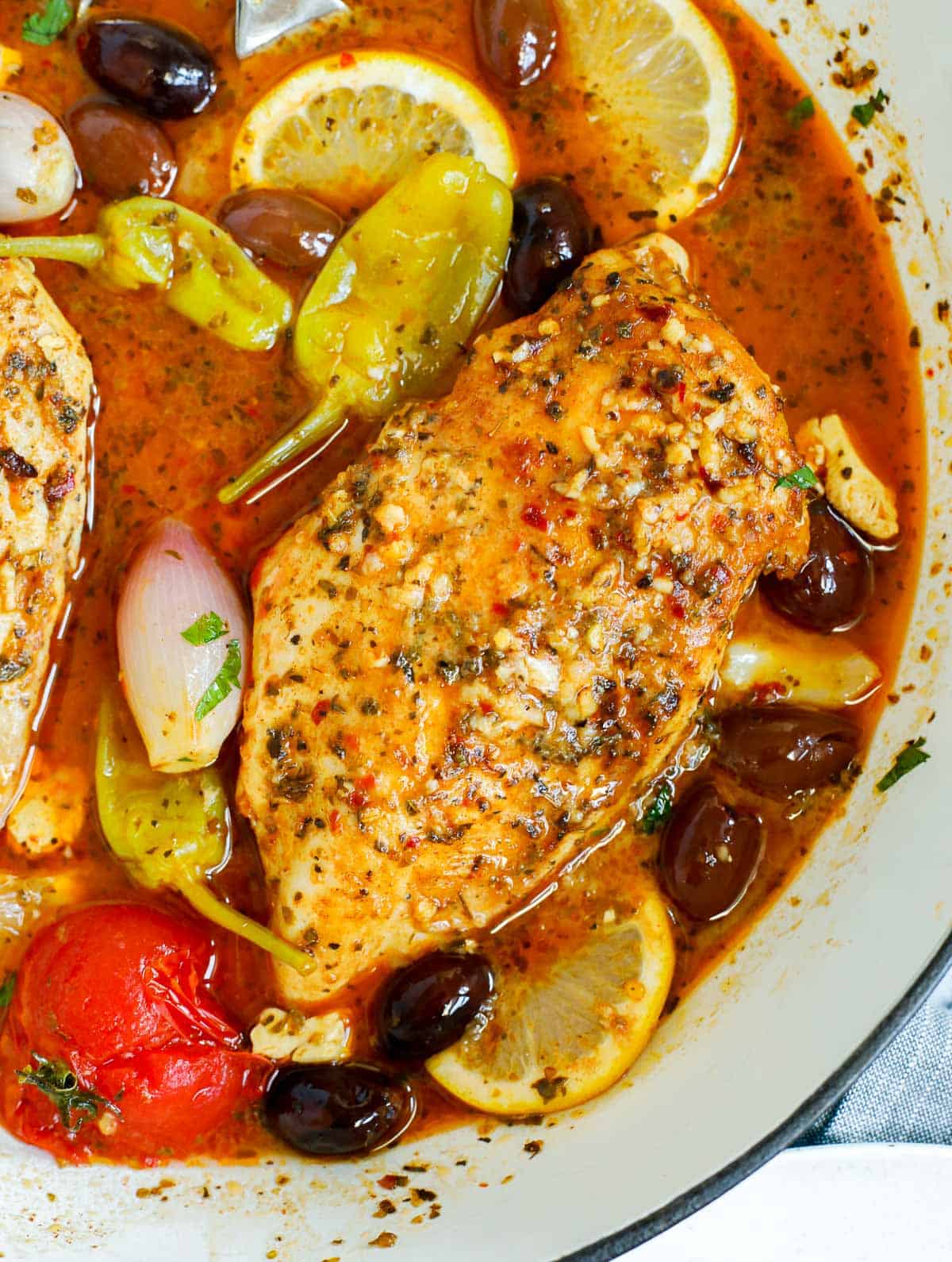 Close up of a pan of oven baked Greek chicken breasts.