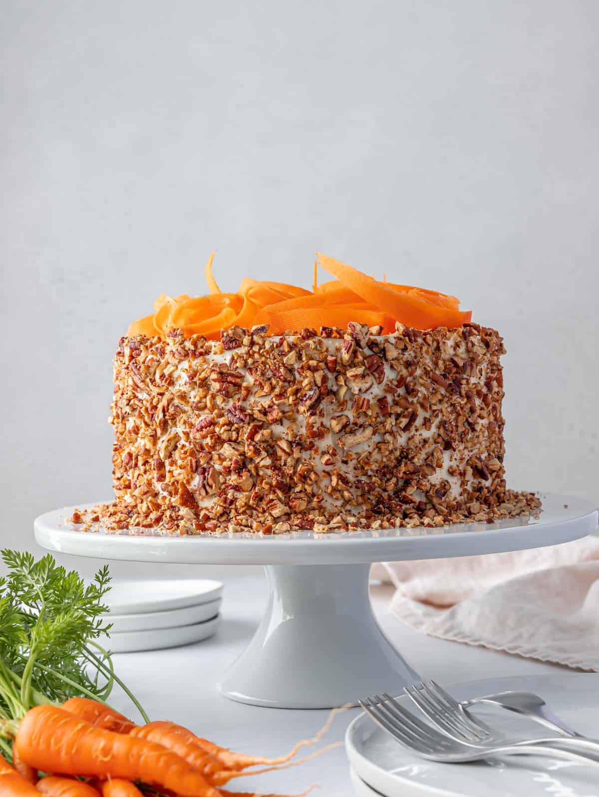 whole decorated carrot cake on a cake stand