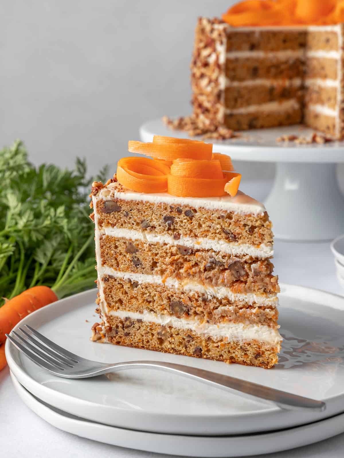 slice of carrot cake on a plate with a fork