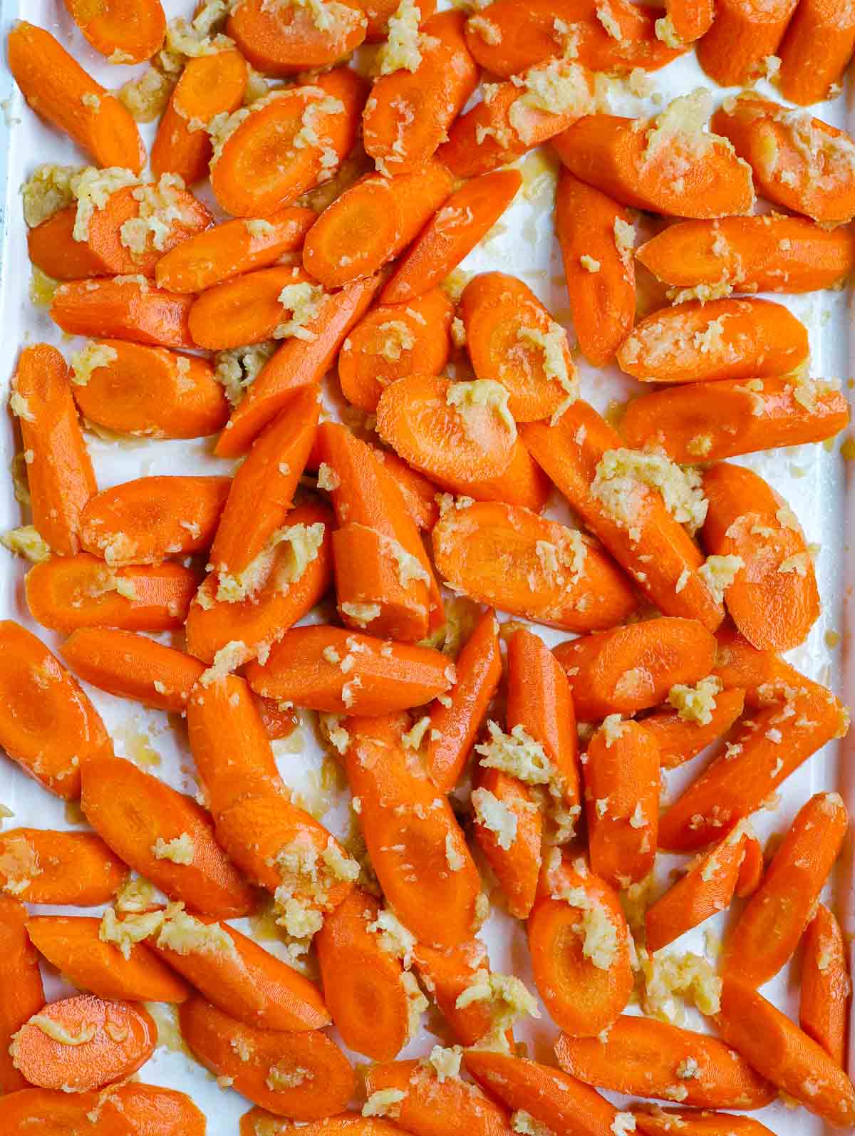 uncooked brown sugar glazed carrots on sheet pan