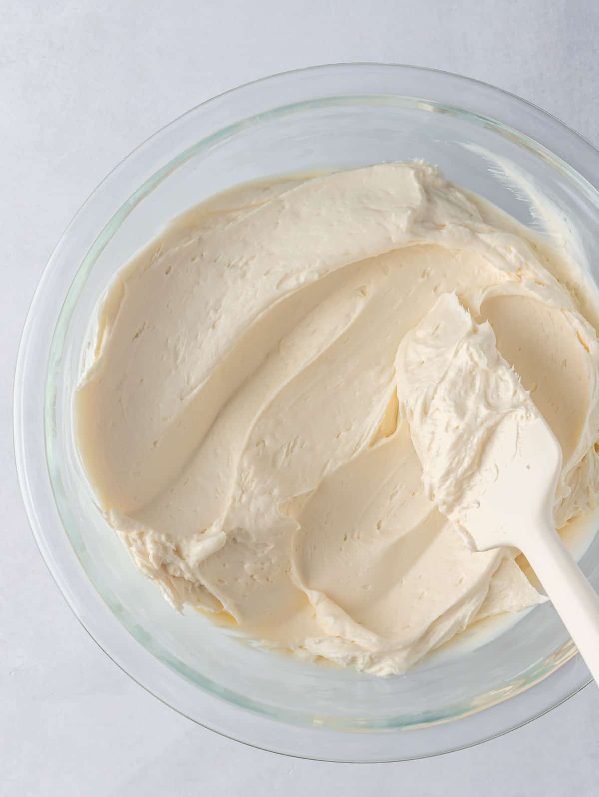 carrot cake frosting in a bowl with a spatula