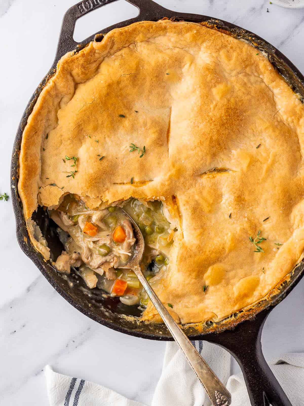 spoon in the skillet with a portion of pot pie removed