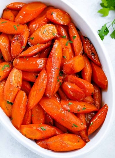 brown sugar glazed carrots in a white serving dish