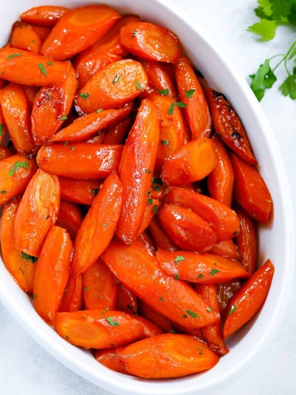 brown sugar glazed carrots in a white serving dish