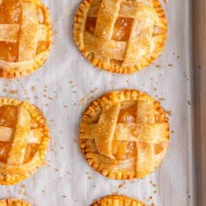 close up shot of the baked mini apple pie on a sheet pan