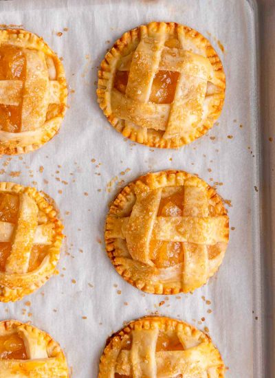 close up shot of the baked mini apple pie on a sheet pan