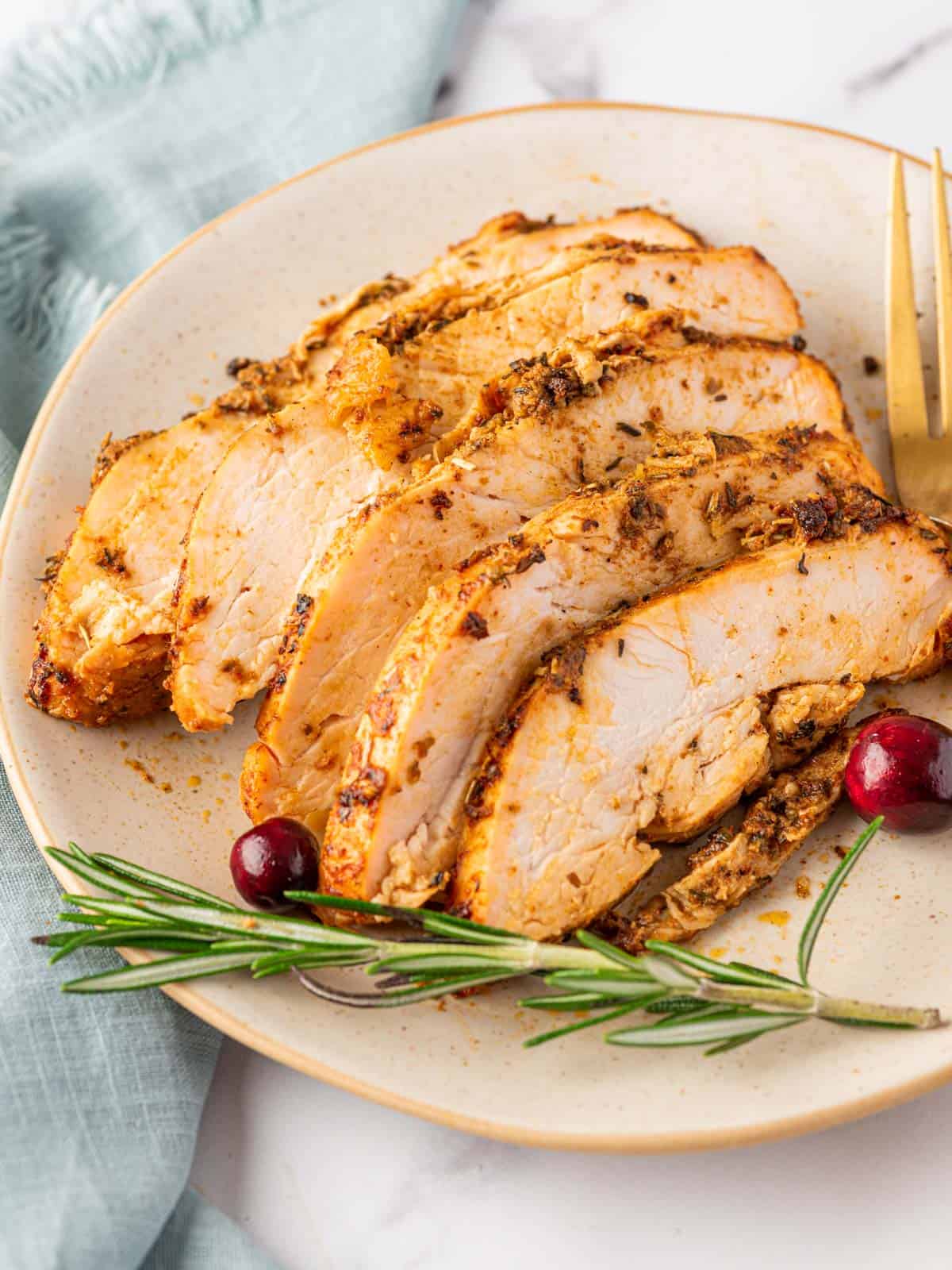 sliced pieces of oven roasted turkey bread on a plate