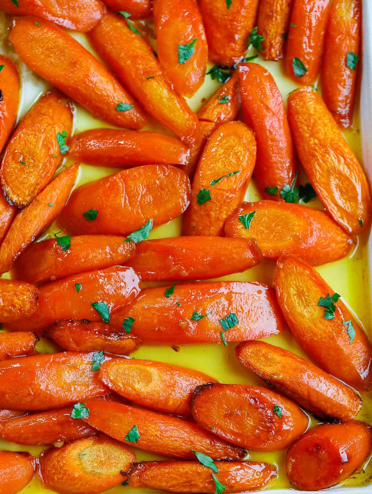 close up shot of the brown sugar glazed carrots on a sheet pan