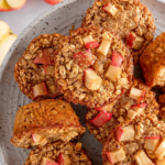 Baked apple oatmeal cups topped with diced apples and turbinado sugar.