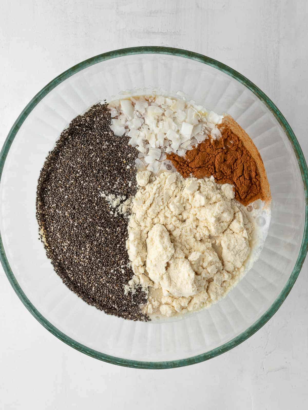 all the ingredients of the protein chia pudding in a bowl