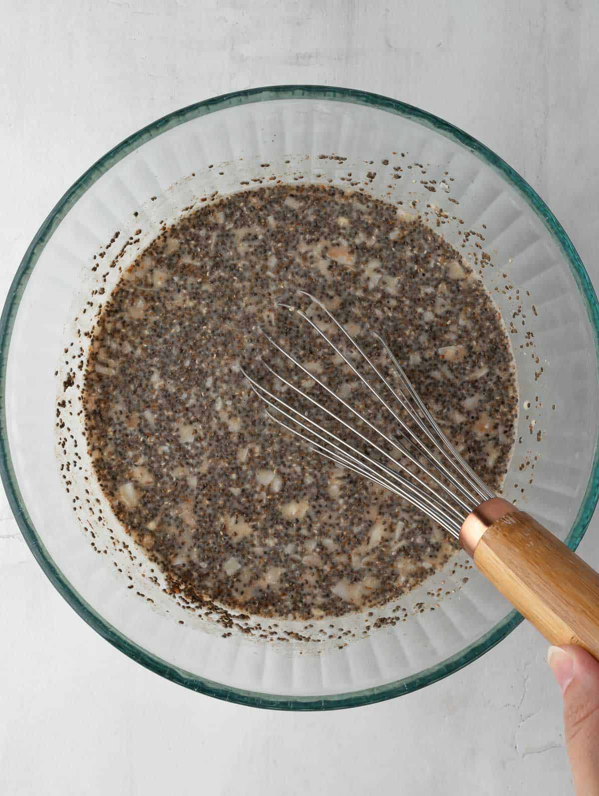 chia seeds being mixed in a bowl