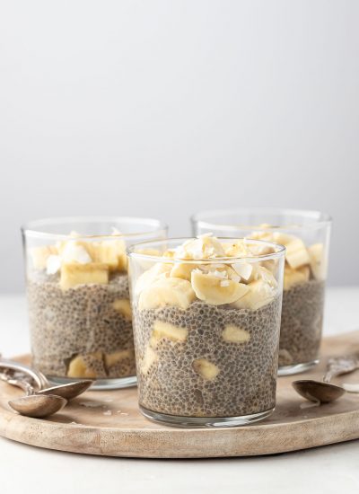 3 cups of banana chia pudding displayed on a wooden bowl