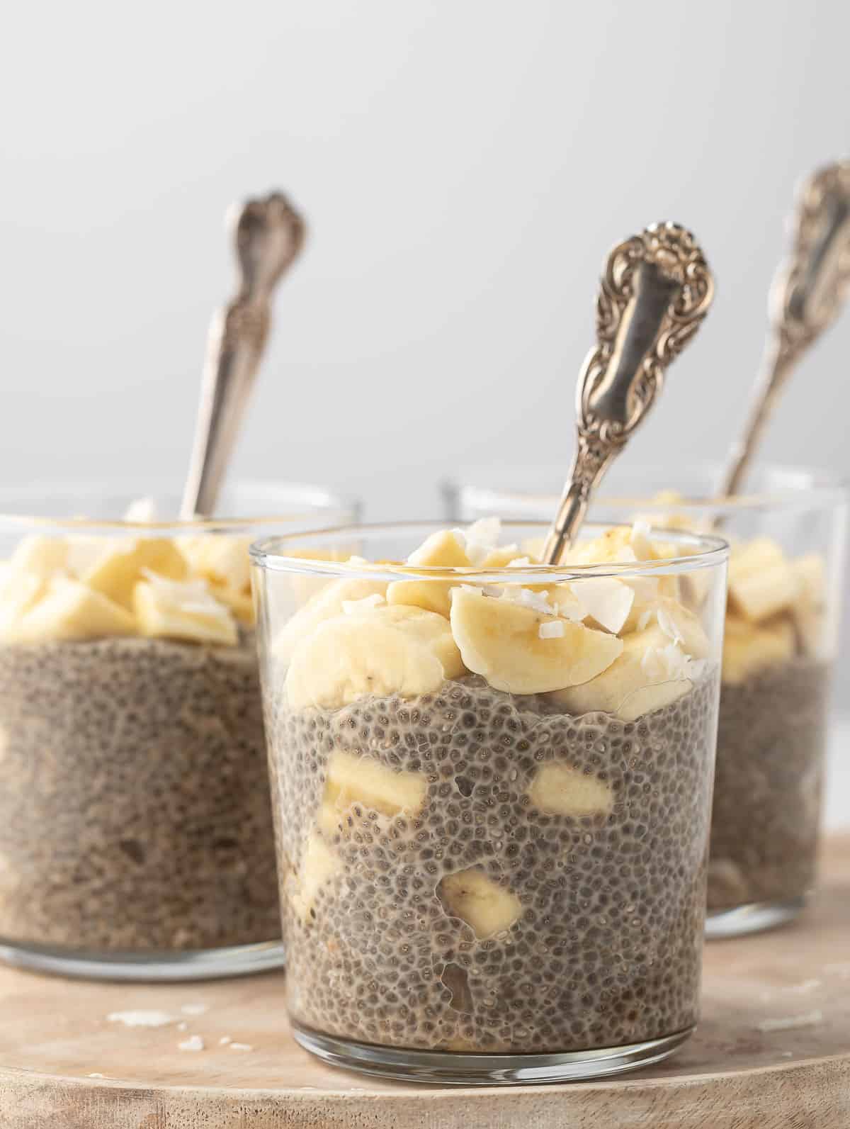 banana chia pudding in a cup with a spoon inside