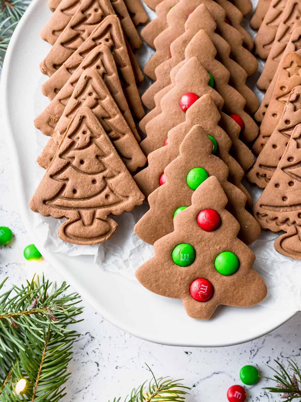 christmas tree gingerbread cookies on a white plate