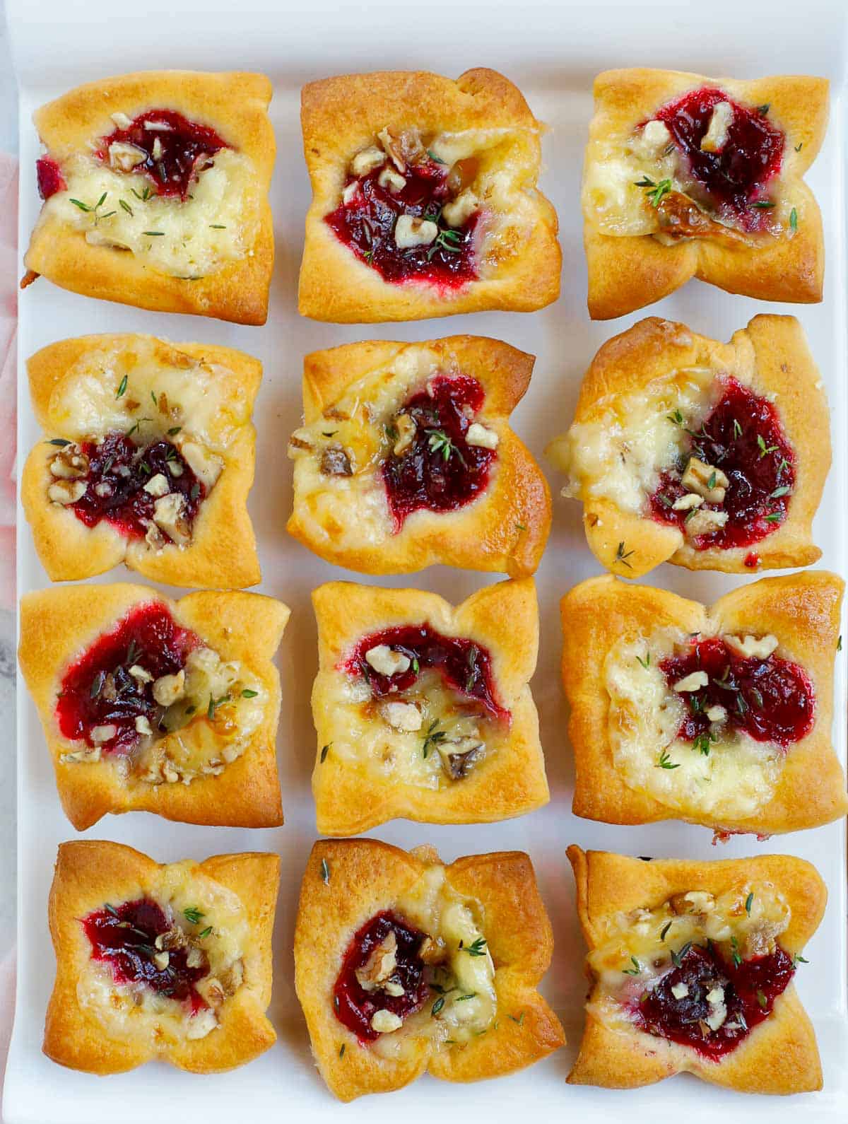 Baked brie bites served on a plate.