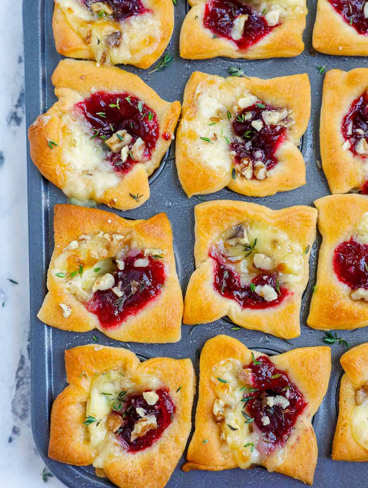 Cranberry and brie bites after baking in a tin pan.