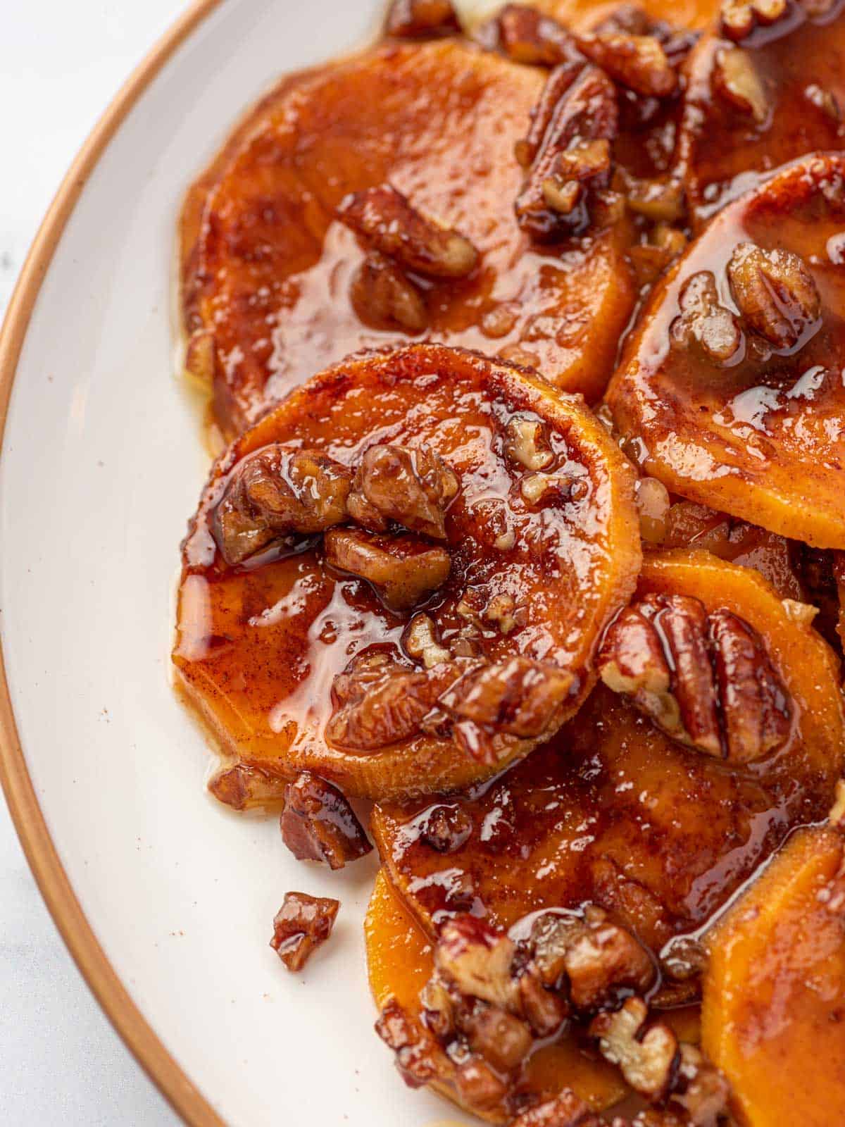 close up shot of candied sweet potatoes served on a plate