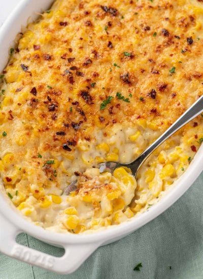 creamed corn casserole with a spoon scooping out some corn